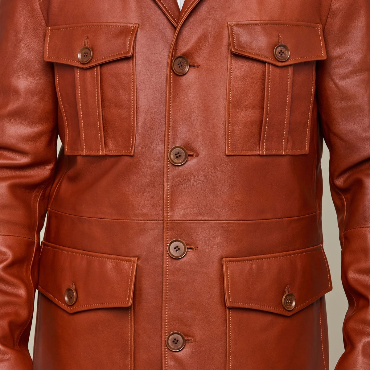 Picture of a model wearing our Leather cargo Jacket, brown color, close up front view showing all 4 pockets.