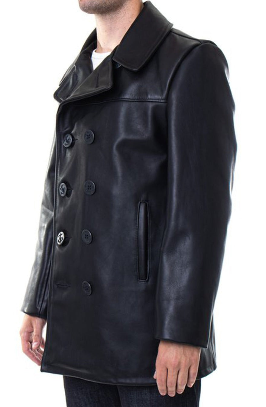 Picture of model wearing mens leather pea coat in black, side view.