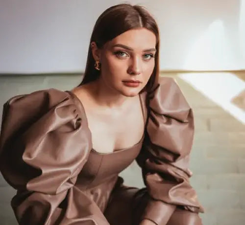 Picture of a model wearing a brown leather dress