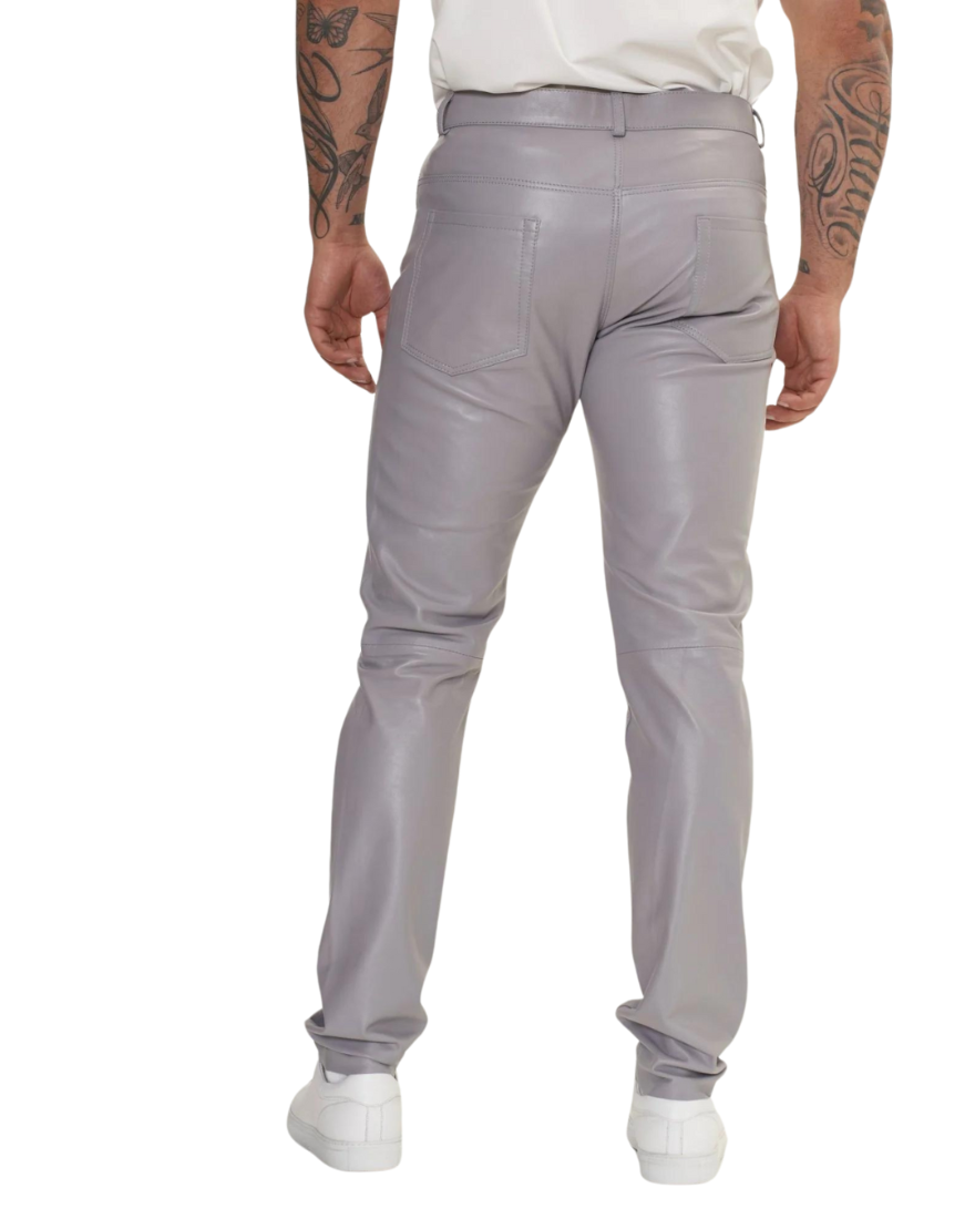 Picture of a model wearing our light grey leather pants. Back view.