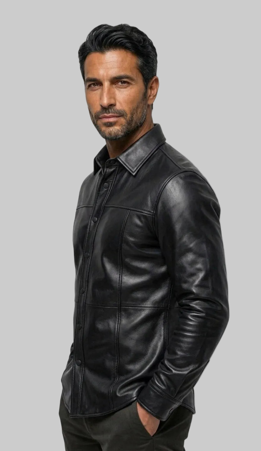 A man wearing our  Black Custom Leather Shirt for Men posed in profile against a off white background.
