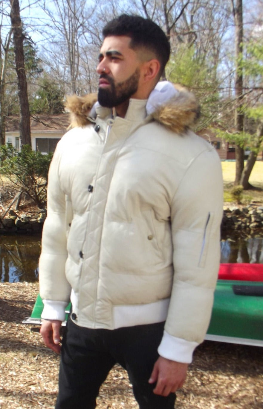 Picture of a model wearing our White Leather Puffer Jacket, side view with zipper closed and hood down.