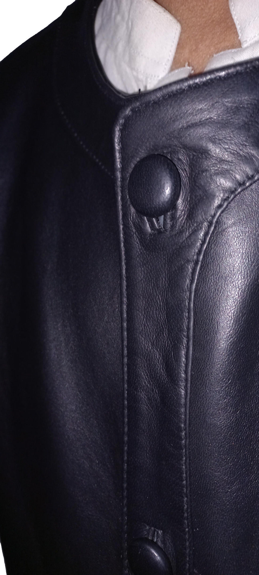 close up picture of the leather covered snap buttons on our leather button up shirt.