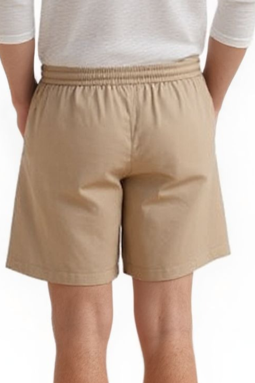 Man wearing a  white shirt and our Men&#39;s Beige Leather Shorts, back view.