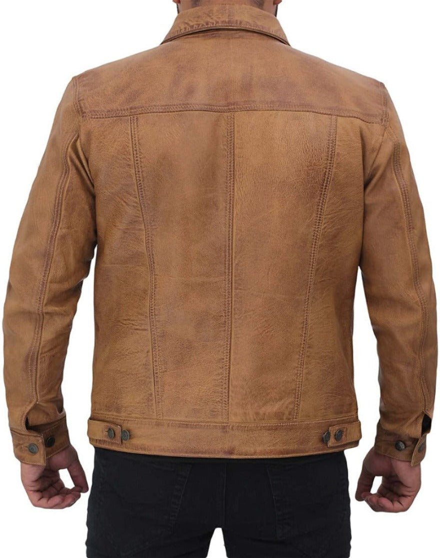 Picture of a model wearing our tan leather trucker jacket, back view .