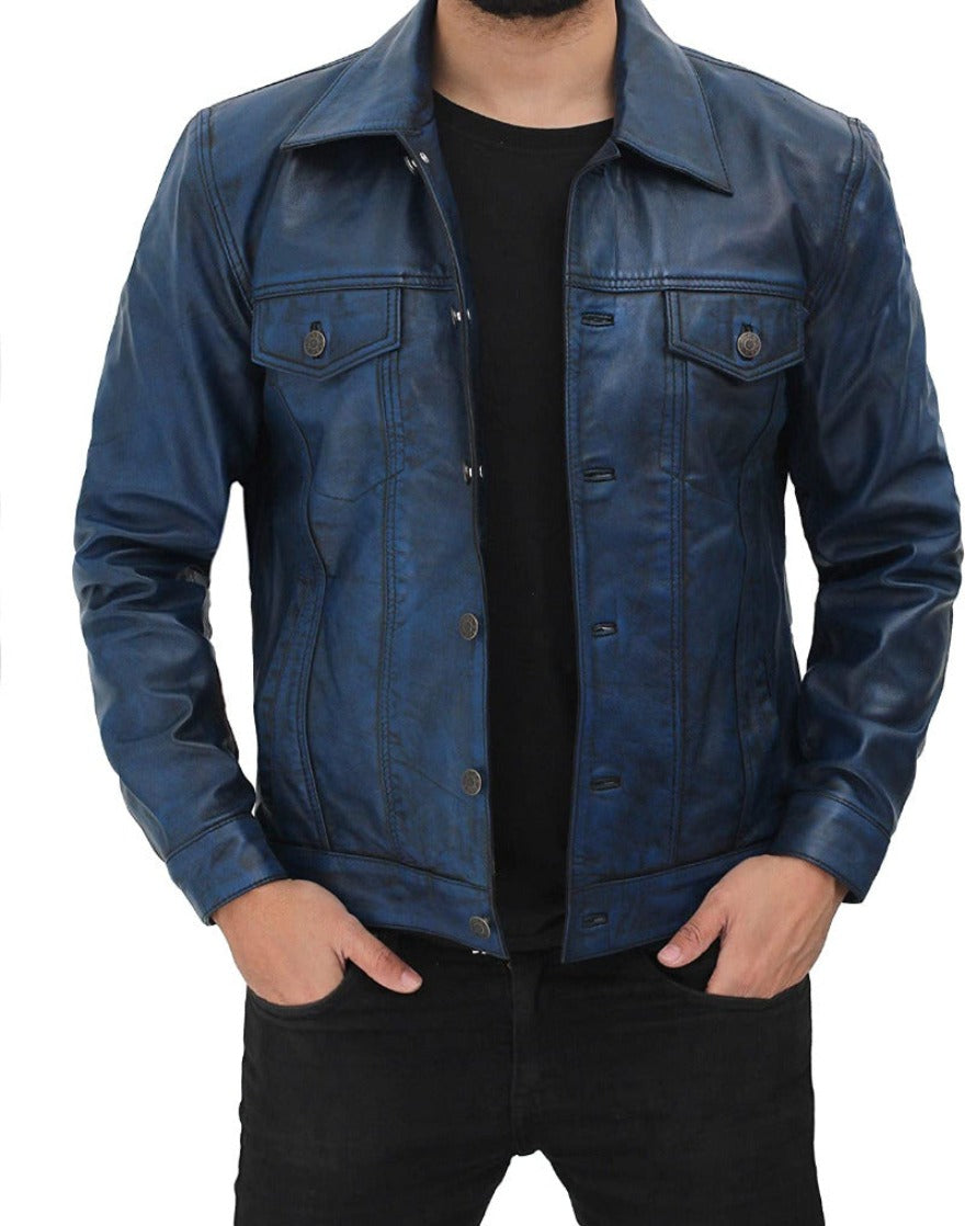 Picture of a model wearing our blue leather trucker jacket,  front view.