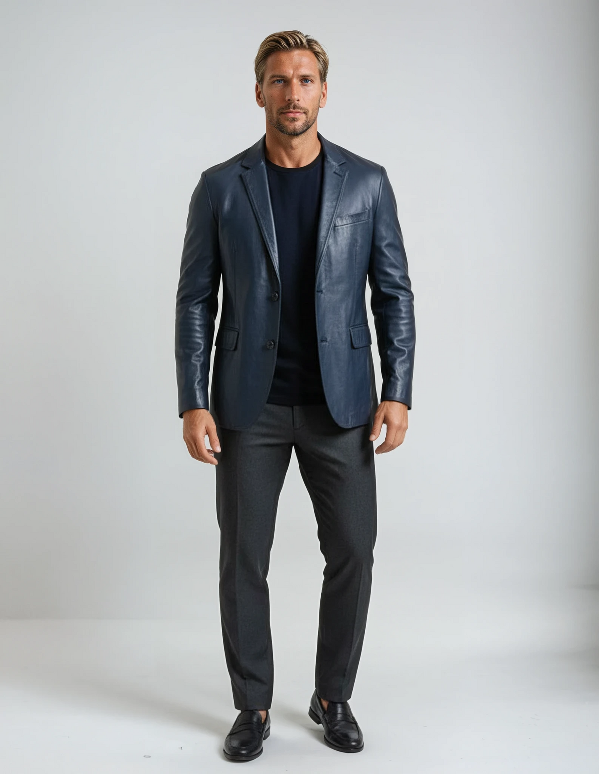 Man wearing a dark blue leather sport  jacket and black pants on a white background