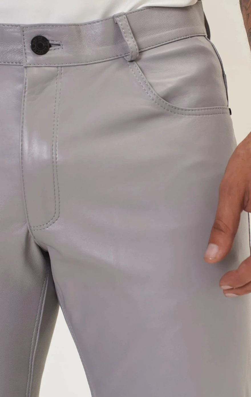 Picture of a model wearing our light grey leather pants. Close up view of the waist and pocket.