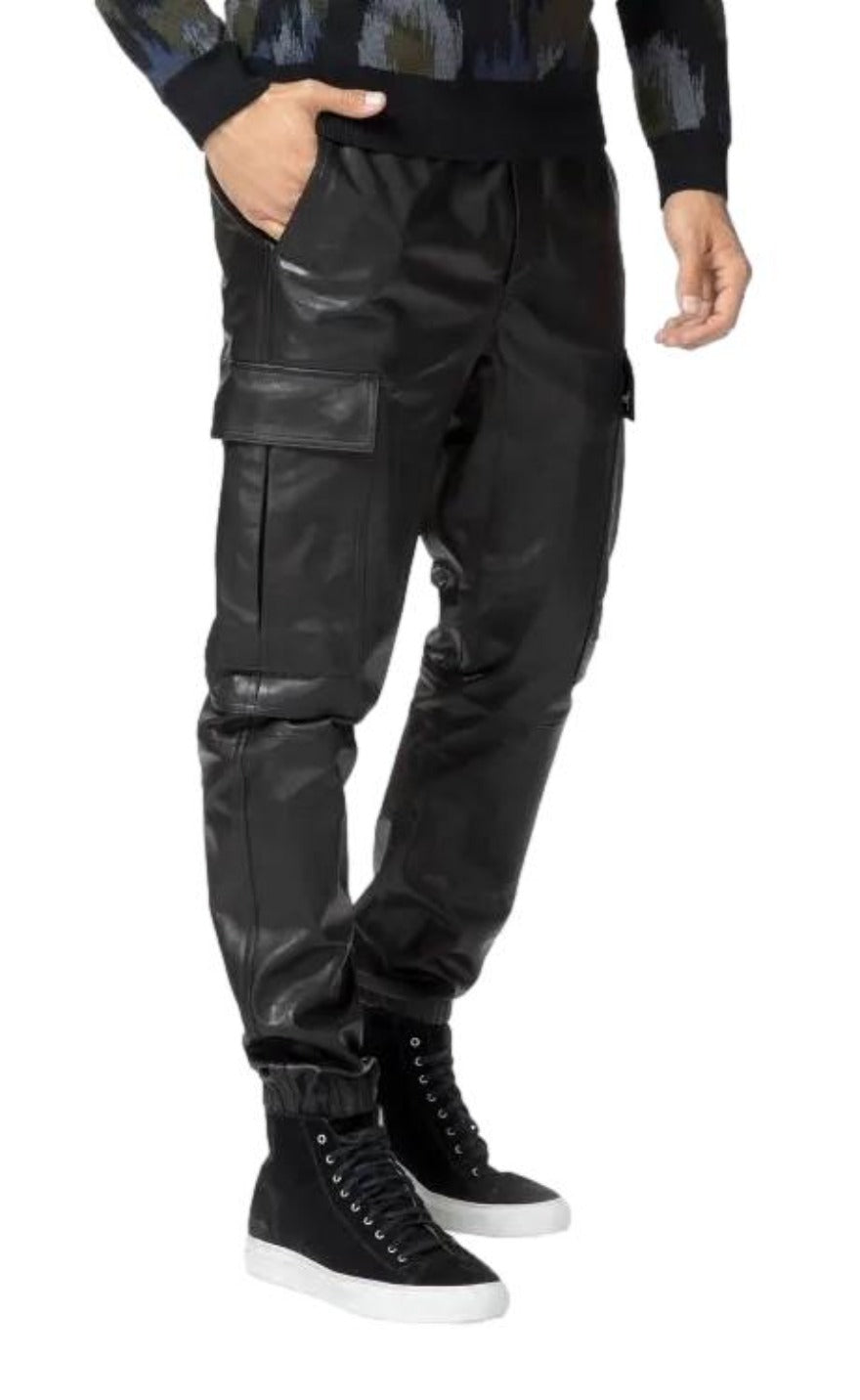 Picture of a model wearing our Black Leather Cargo Pants, side view.