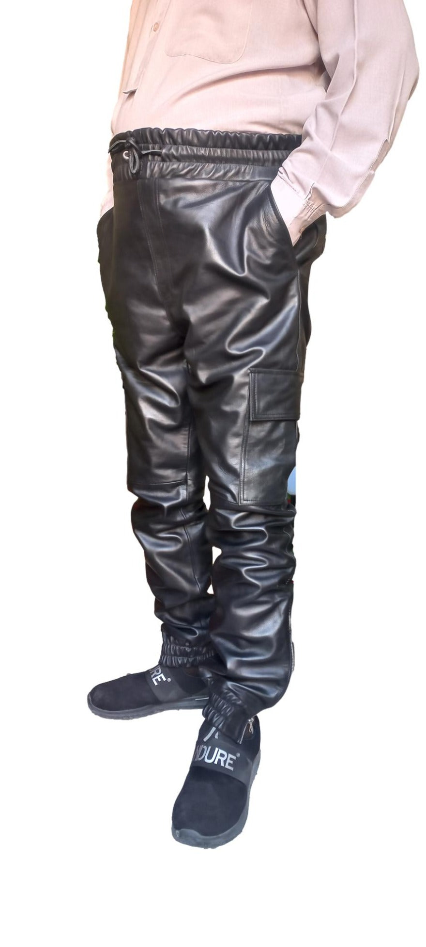 Picture of a model wearing our Black Leather Cargo Pants, side view.
