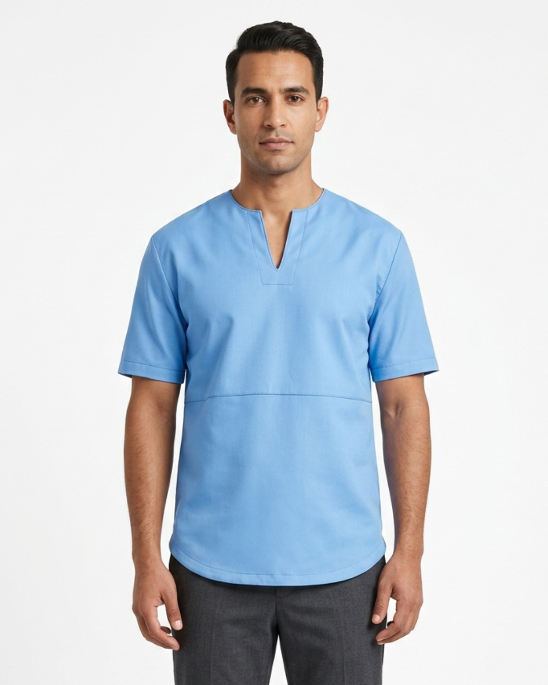 A man wearing a light blue short-sleeve leather tee with a split V-neck, paired with dark gray pants, standing against a plain white studio background.