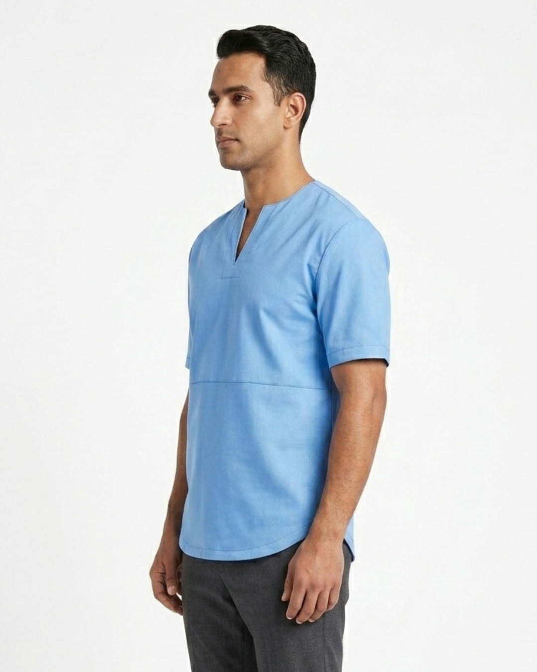 A man wearing a light blue leather tee shirt with a split V-neckline, shown from a side profile against a plain white studio background.