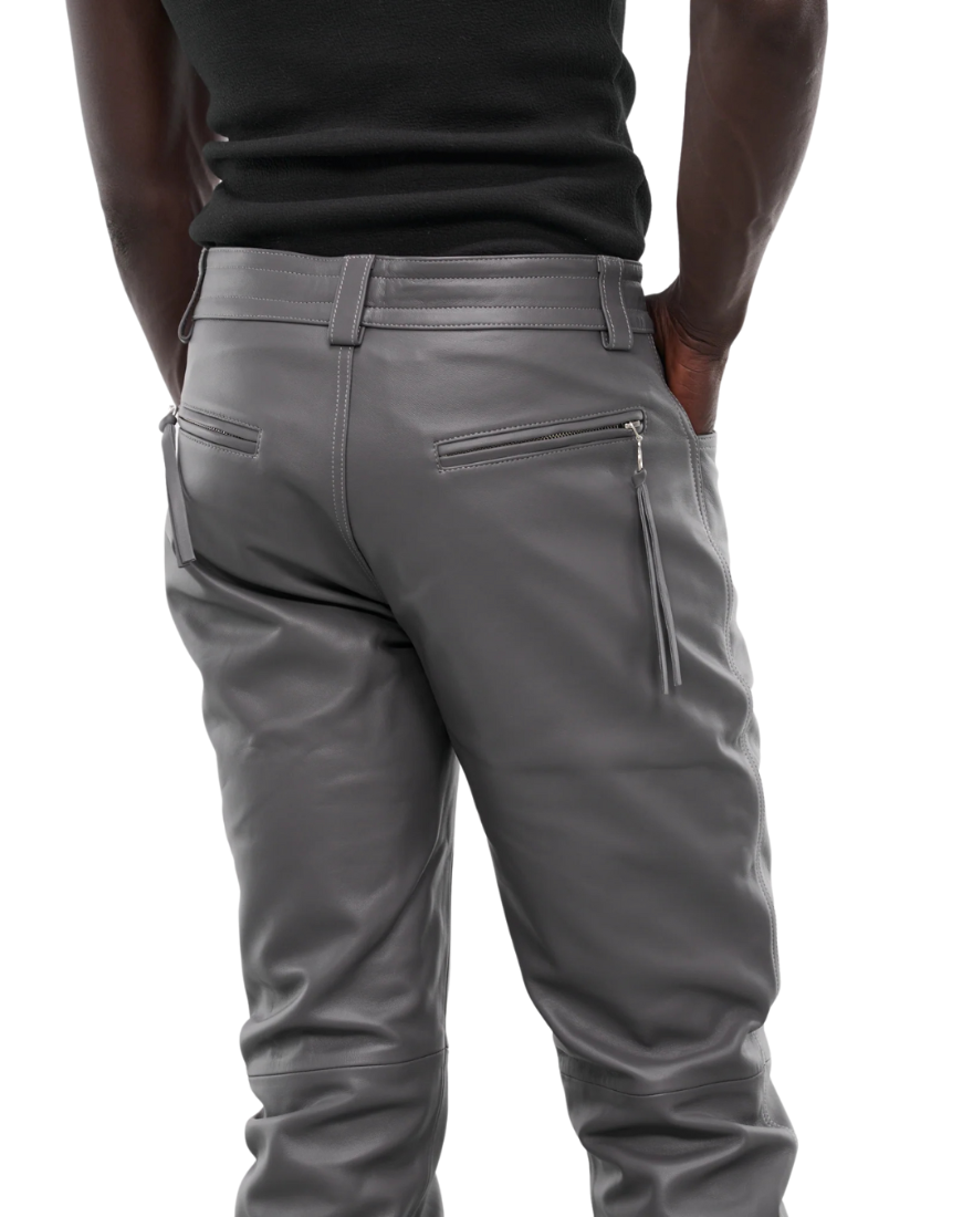Picture of a model wearing our Light Grey Leather Pants, back view. 