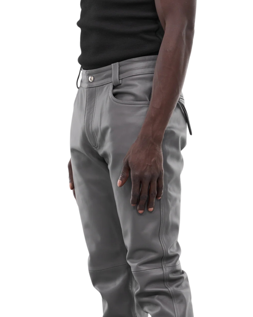 Picture of a model wearing our Light Grey Leather Pants, side view. 