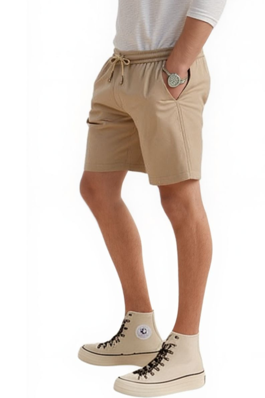 Man wearing a  white shirt and our Men&#39;s Beige Leather Shorts, side view.