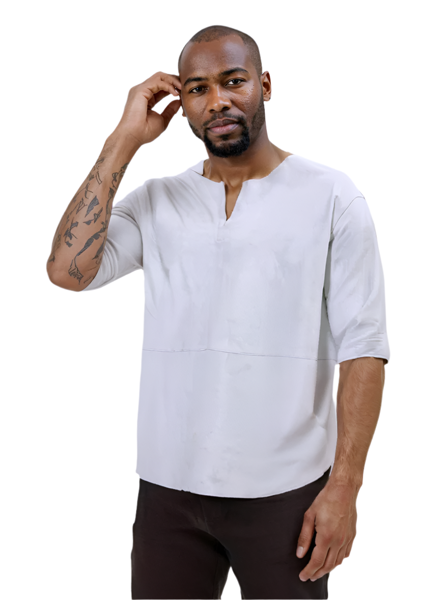 Man wearing a white short-sleeve leather tee shirt and dark pants against a white background, front view.