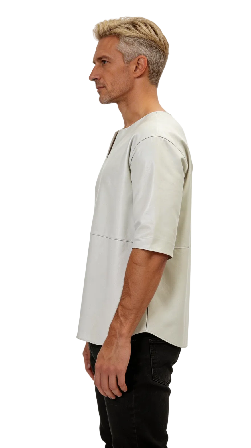 Man wearing a white short-sleeve leather tee shirt and dark pants against a white background, side view.