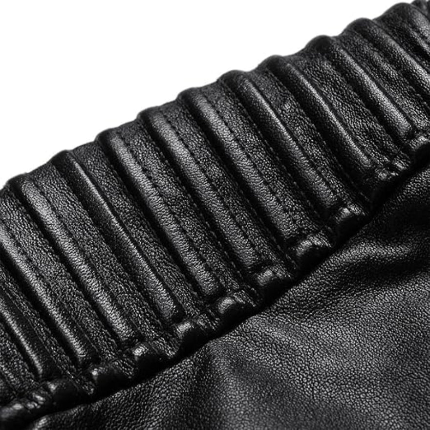 A black leather cafe racer jacket with a standing collar, zippered front, and ribbed shoulders, close up view of the ribbing on shoulder.