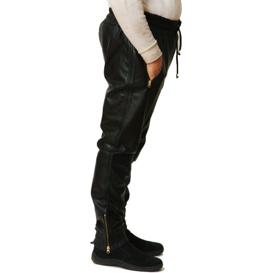 Picture of a model wearing our Mens Black Leather Joggers, side view.