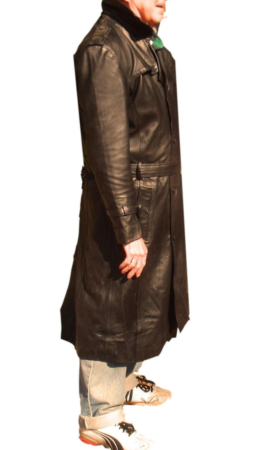 Picture of a model wearing our mens black leather trench coat full length side view.