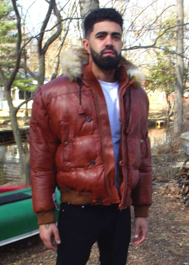 Picture of a model wearing our Brown Puffer Leather Jacket, front view with fur trimmed hood down..