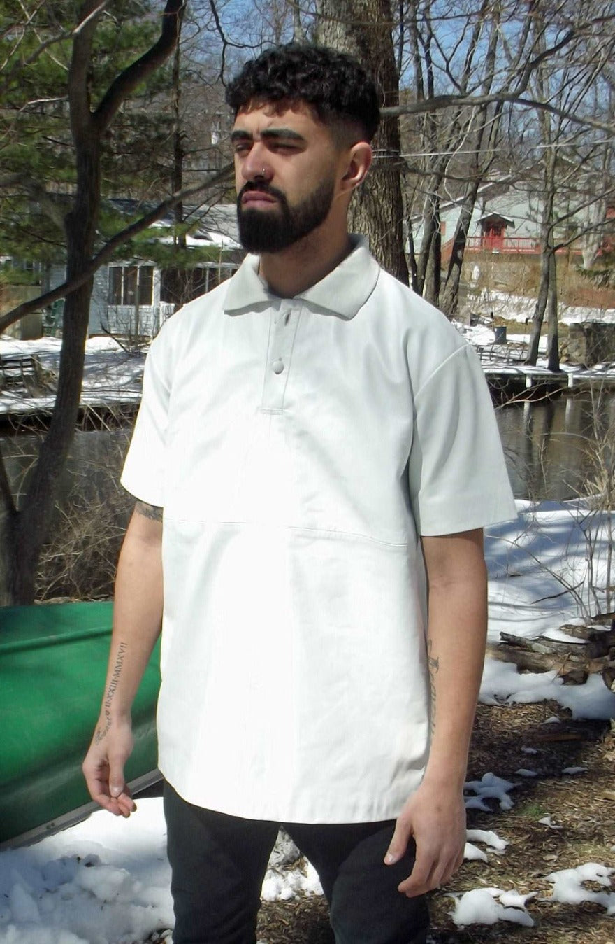 Picture of a model wearing our Leather Polo shirt. Color is white, front view