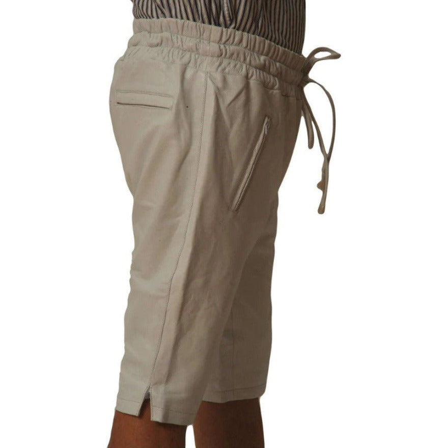 Picture of a model wearing our Mens White Leather Shorts, side view.