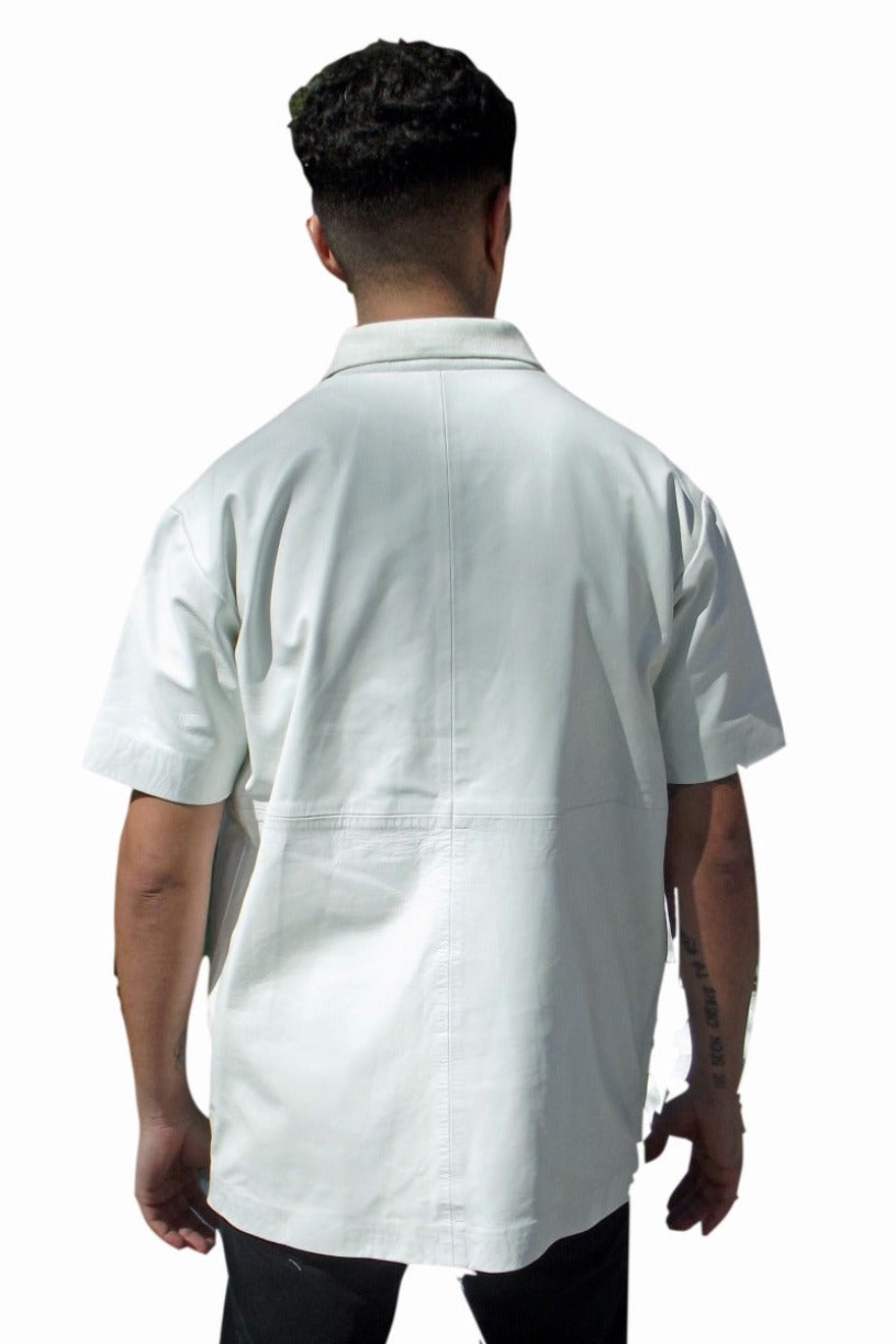 Picture of a model wearing our Leather Polo shirt. Color is white, back view