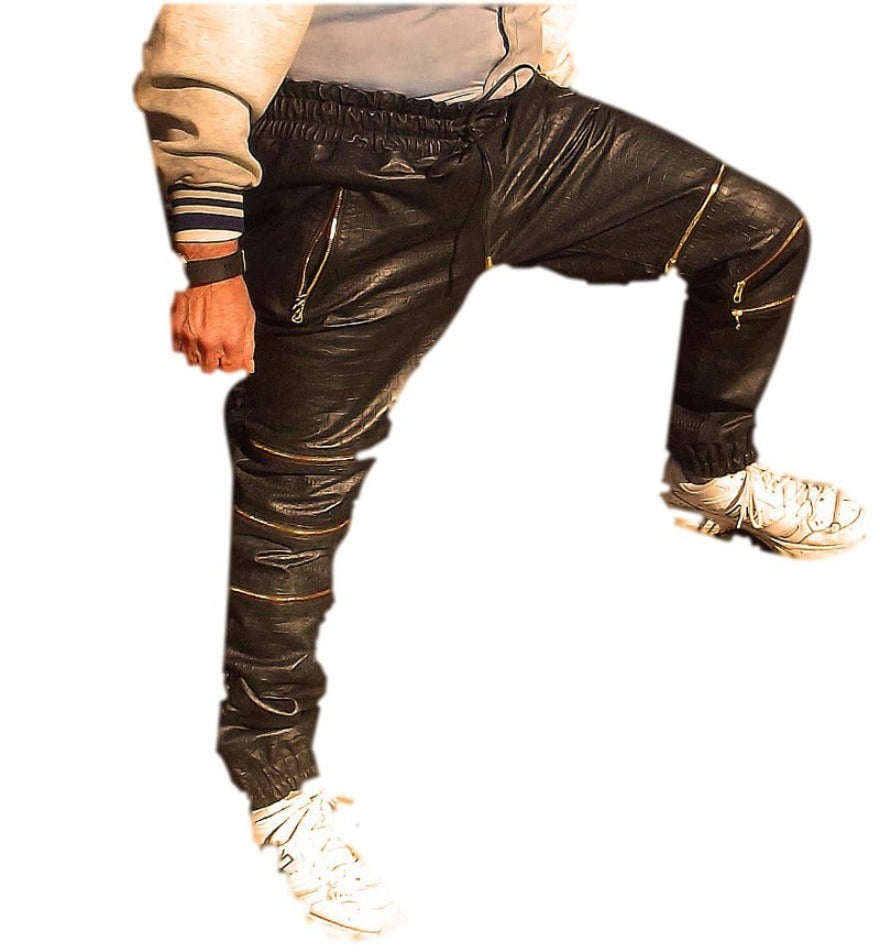 Picture of a model wearing our black snakeskin leather joggers with 3 knee zippers, front view.